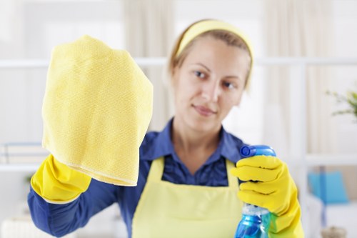 Professional oven cleaner preparing a kitchen oven with safety measures in Battersea